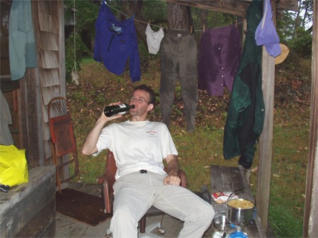 Scott on cabin porch near Anderson Island Washington Water Trails Associatino WWTA campsite, Puget Sound, Washington