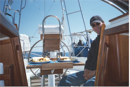 Jim In Cockpit Of Miracle Girl Crealock 34 sailboat