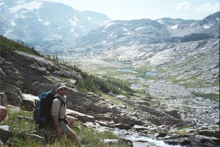 Scott Looking Out Over Valley Of Mountains, Rocks, Lakes, And Waterfalls In Beartooth Mountains Of Montana