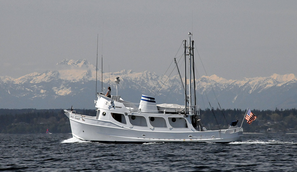 Trawler boat on Puget Sound with Olympic Mountains and Bainbridge Island background