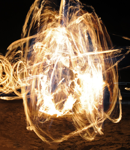 Golden Gardens fire spinner dancer performer swirls at Bonfire and Christmas Tree Immolation Party