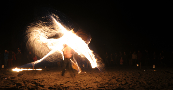 Golden Gardens fire whip spinner performance at Bonfire and Christmas Tree Immolation party