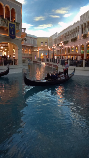 The Venetian in Las Vegas with gondola on an interior canal surrounded by shops