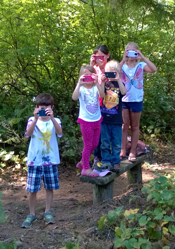 Kids taking pictures with phones along Coastal Forest Trail in Cape Disappointment State Park