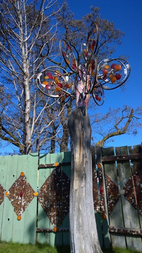 Dick and Janes Spot Ellensburg bike wheel reflectors on tree  wind sculpture