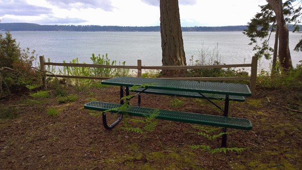 Picnic bench by Puget Sound beach at end of trail around Jacobs Point Park on Anderson Island