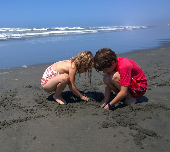 Cape Disappointment State Park kids digging in sand beach