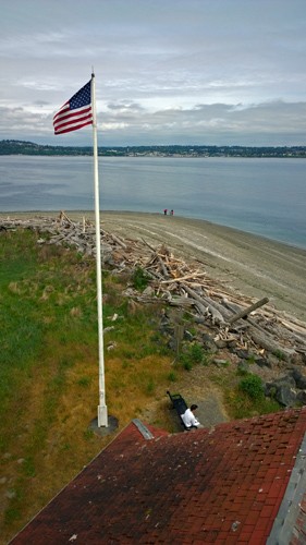 American flag from Point Robinson Lighthouse at Point Robinson Park on Maury Island by Vashon Island