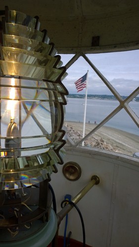 Light and American flag from Point Robinson Lighthouse at Point Robinson Park on Maury Island by Vashon Island