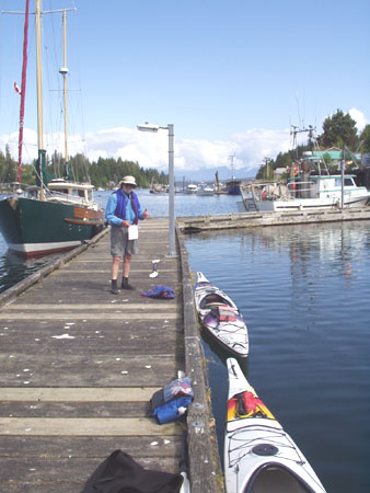 Dad Ready To Launch Sea Kayaks From Bamfield's Eastern Public Dock, Vancouver Island, British Columbia, Canada
