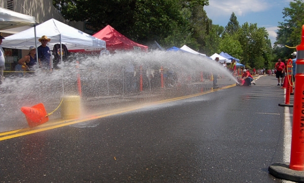 Murphys Firemans Muster Shooting Water From Fire Hose At Traffic Cone Target On Main Street As Part Of Fire Hose Cart Competition
