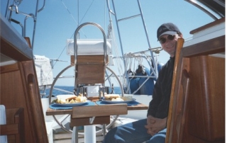 Jim In Cockpit Of Miracle Girl Crealock 34 sailboat