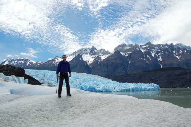 Scott On Top Of Glaciar Grey / Glacier By Lago Grey / Lake With Cerro Paine Grande Looming Above In Parque Nacional Torres Del Paine / National Park, Chile