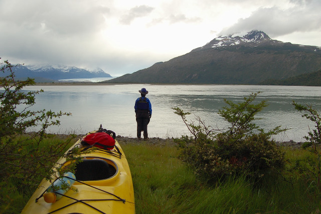 Karen And Kayak On The Shore Of The Rio Serrano / River By Parque Nacional Torres Del Paine / National Park,  Chile