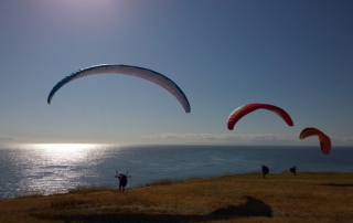 Fort Ebey State Park 3 paragliders at bluff edge overlooking Strait of Juan de Fuca