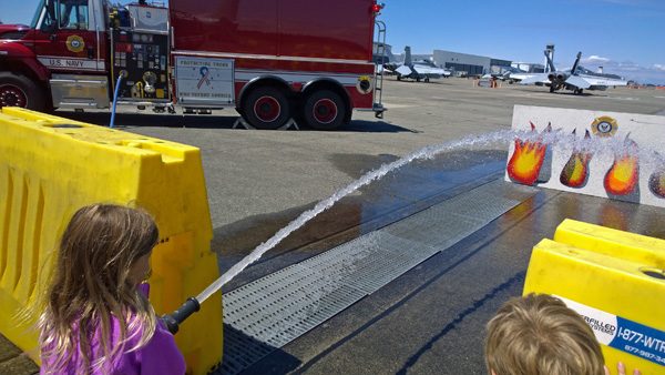Children spraying real fire hose at Naval Air Station Whidbey Island Open House Oak Harbor