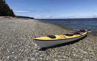 Triple sea kayak on Saratoga Passage beach Coupeville Whidbey Island