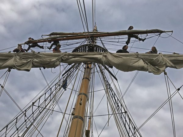 Hawaiian Chieftain crew up mast and rigging in Coupeville Penn Cove