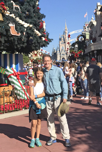 Walt Disney World at entrance to Magic Kingdom by Christmas tree and Cinderella castle